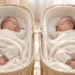 Two sleeping babies resting in separate woven bassinets, wrapped in soft neutral blankets in a calm, cozy nursery setting